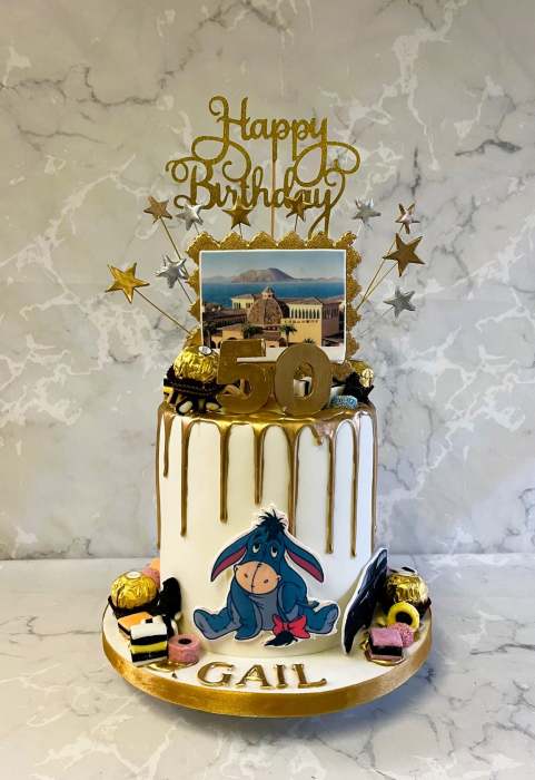 Drip style birthday cake with sugar cut-outs and  sweets
