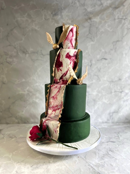 Peeled back Dark green icing revealing Marbling and gold  With Harry Potter and Beauty and the Beast  hod