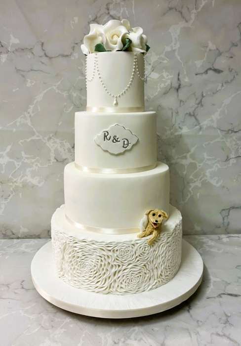Sugar embossed Rosettes wedding cake with pearls  and sugar peeping Dog