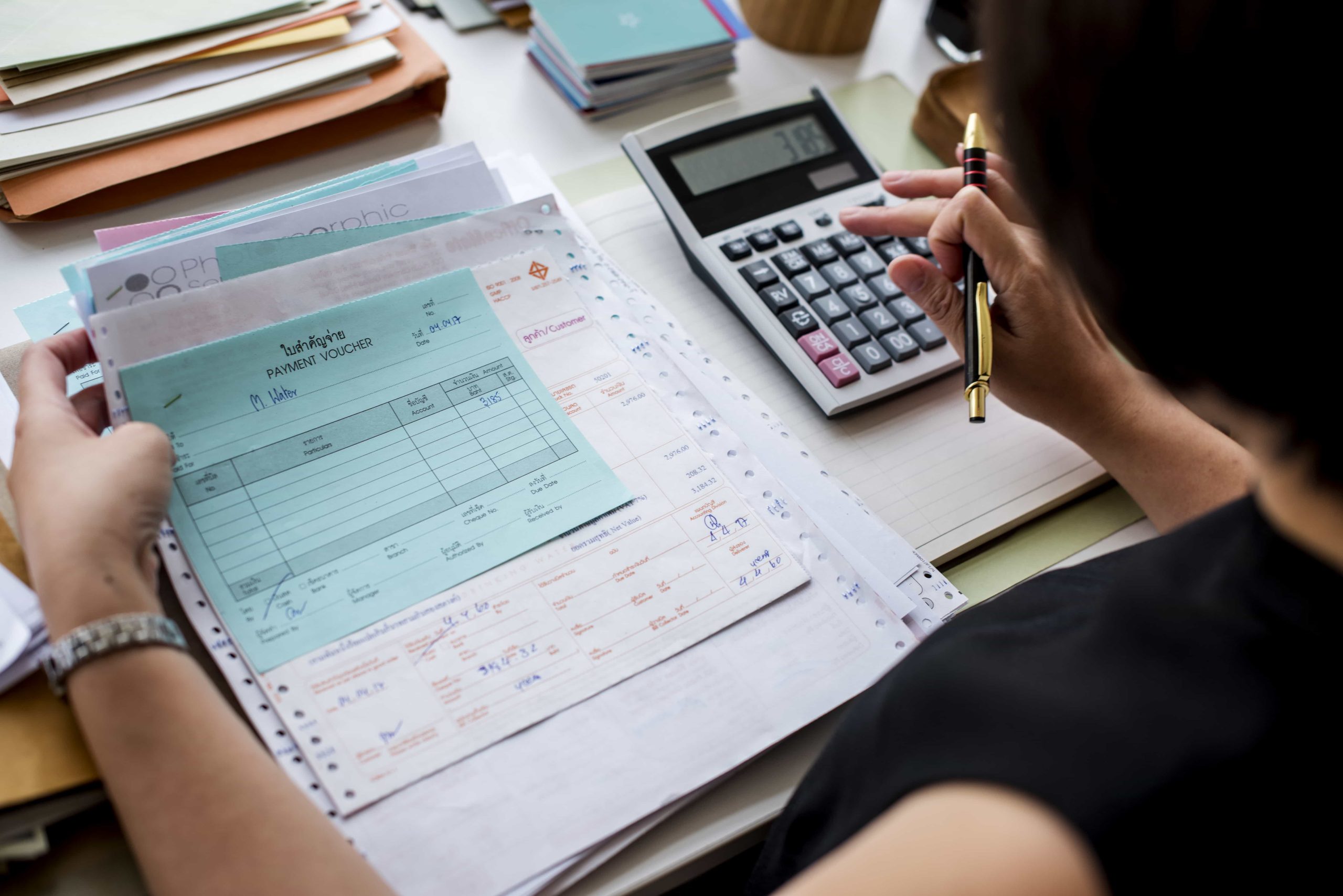 asian-woman-working-through-paperwork-min